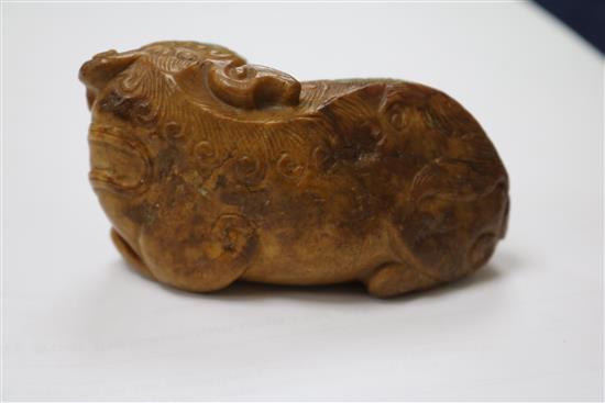 A Chinese greenish yellow and russet jade figure of a Buddhist lion, 17th/18th century 8cm.